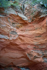 Stunning geological formations reveal layers of red rock in a serene natural landscape during the golden hour of twilight