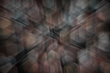 Abstract motion blur background with radial light streaks in brown and gray tones. Dynamic speed effect with central focal point for modern design projects.