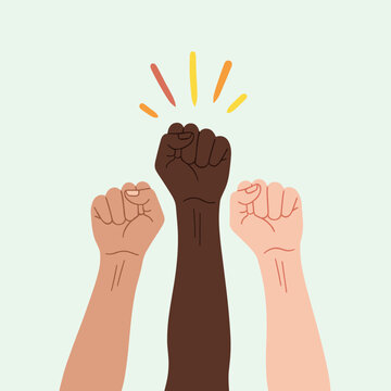 Diverse hands raise fists in solidarity and unity showing strength together