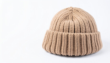 Beige knit beanie hat isolated on white backdrop. Headwear fashion.