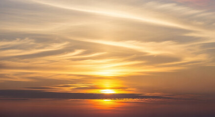 Obraz premium Dramatic Golden Hour Cloudy Sky Landscape in a Warm Natural Setting
