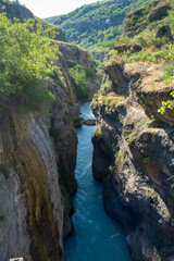 a river in a stone canyon. a river in the mountains