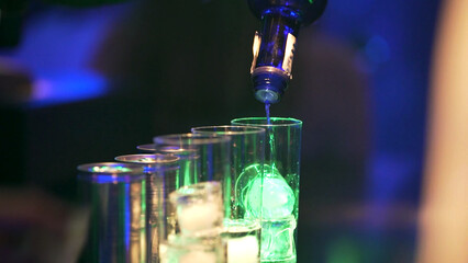 serving drinks at the bar of a nightclub.
