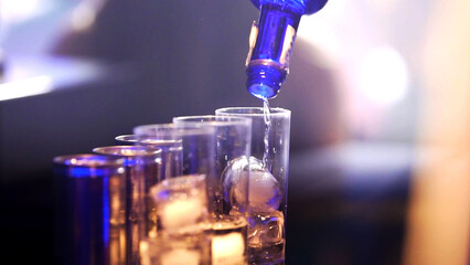 serving drinks at the bar of a nightclub.
