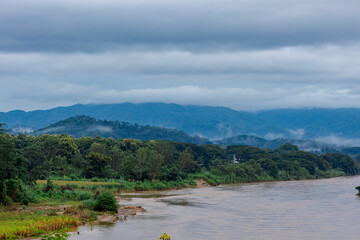 A close-up view of the natural atmosphere surrounded by mountains, grasslands and mist from the cold, humid air. The joy of traveling and experiencing nature.
