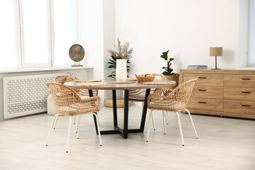 Stylish table with chairs and decor in dining room. Interior design