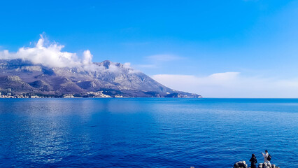 Group of travelers enjoy view of Becici Vidkovac penisula near Budva Montenegro.