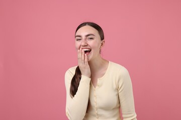 Beautiful woman laughing on pink background. Positive emotion