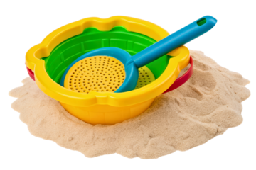 Colorful plastic beach pail and shovel set in a pile of sand isolated with transparent background