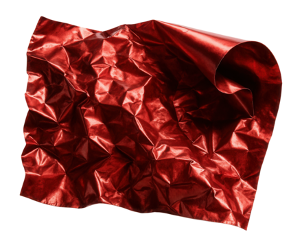 Crumpled red metallic foil with curled edge reflecting light.