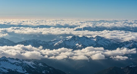 Majestic Snow-Capped Mountain Peaks Emerging from a Sea of Clouds Under a Clear Blue Sky