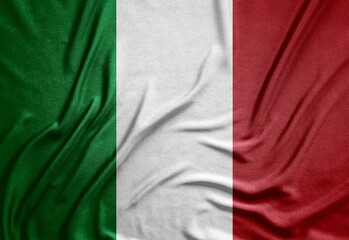 tricolor flag of the Republic of Italy on a rough canvas with folds and shadows