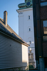 Urban contrast highlighted by historical architecture alongside modern buildings in a quiet street during daylight