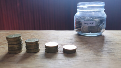 Savings Jar and Descending Coin Stacks