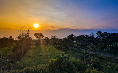sunrise, sunset, mountain, landscape, nature, rural, field, grass, trees, mist, golden hour, scenic, peaceful, countryside, sky, clouds, horizon, twilight, outdoor, panorama, valley, farmland, meadow,