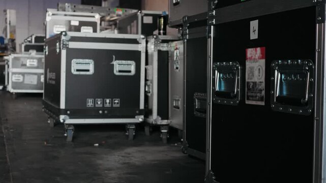 Music acoustics transportation boxes, Sound engineering Installation professional audio equipment live concert,backstage zone. Racks with stereo speakers amplifiers, subwoofer power distribution boxes
