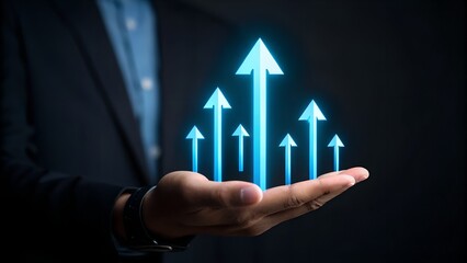Man's hand holds glowing blue arrows symbolizing business growth and success