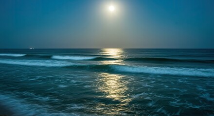 Obraz premium Serene Ocean Waves Under a Luminous Full Moon and Reflective Moonlight Path