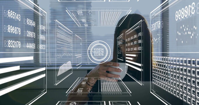 Analyzing businesswoman holding coffee mug at office desk, interacting with floating data panels - Powered by Adobe