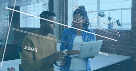 Reviewing code and data charts, two professionals working in tech office with laptop and coffee cup © vectorfusionart