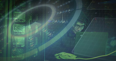 Working hooded engineer using laptop in server room with racks, yellow Ethernet cable, copy space