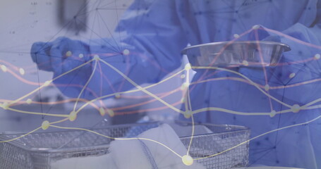 Arranging worker wearing scrubs loading bowls onto wire rack in sterile area with network overlay