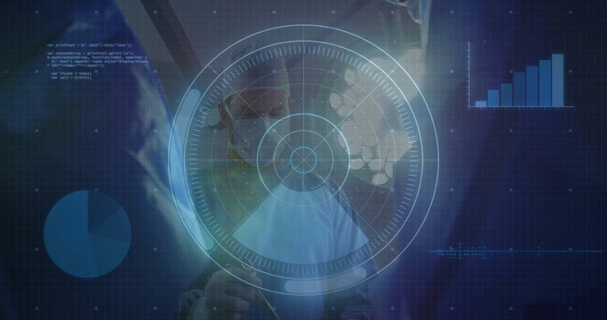 Pointing surgeon wearing surgical attire in lab, with hologram interface, pie chart bar graph