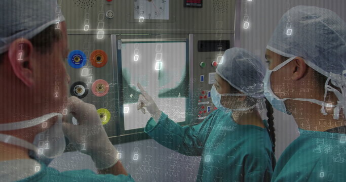 Pointing surgeon highlighting radiograph on X-ray screen at control panel, with dials and clock - Powered by Adobe