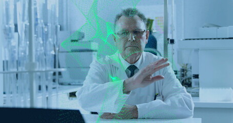 Analyzing senior scientist manipulating green holographic data in research lab, with test tubes