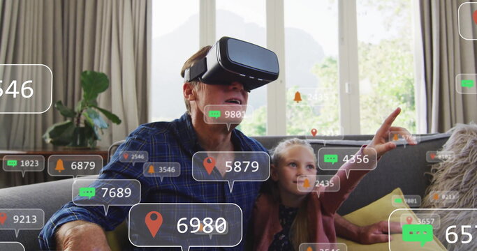 Grandpa and grandchild playing VR game with headset in living room, with floating digital overlays