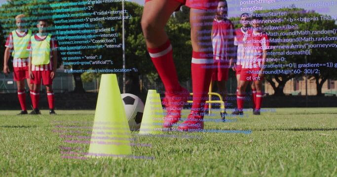 Red-jerseyed soccer player dribbling ball through cones, hurdles on grass field, with code overlay