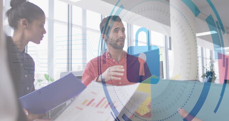 Discussing colleagues wearing business attire presenting charts in office, with digital padlock