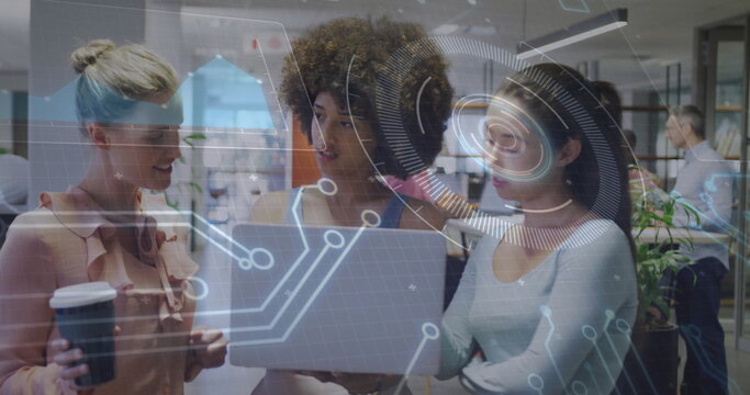 Discussing women collaborating around laptop in open-plan office, with coffee and digital overlay