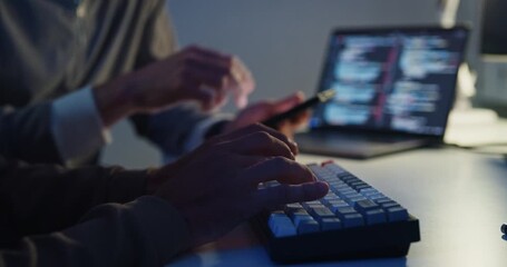 Closeup team adult male engineer collaborate on robotic hand project use AI code solutions machine learn at tech workspace night. Artificial intelligence interface collaboration prototype development. - Powered by Adobe