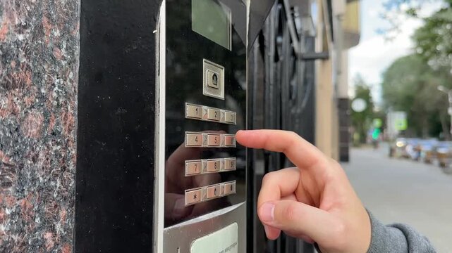 Man dials the apartment number on the intercom