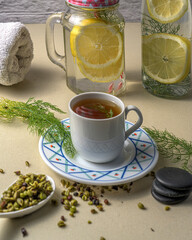 Fennel tea with lemon water bottles and a towel. A healthy and wellness concept