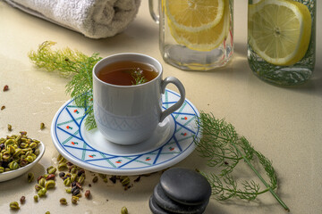 Fennel tea with lemon water bottles and a towel. A healthy and wellness concept