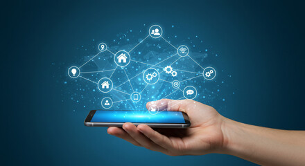 A hand holds a smartphone with a network of interconnected icons floating above it, representing connectivity and digital interaction on a blue background.