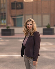 Fototapeta premium Portrait of a beautiful young blonde girl in a city park.