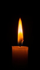 Single candle flame illuminating dark background creating a sense of warmth and reflection representing hope remembrance or tranquility