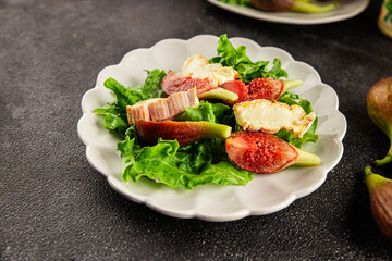Salad figs, soft cheese, green leaf lettuce tasty snack fresh delicious gourmet food background on the table rustic food top view copy space keto and paleo diet vegetarian food