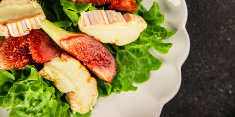Salad figs, soft cheese, green leaf lettuce tasty snack fresh delicious gourmet food background on the table rustic food top view copy space keto and paleo diet vegetarian food