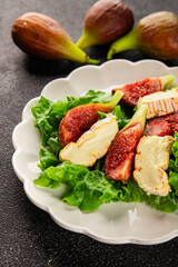Salad figs, soft cheese, green leaf lettuce tasty snack fresh delicious gourmet food background on the table rustic food top view copy space keto and paleo diet vegetarian food