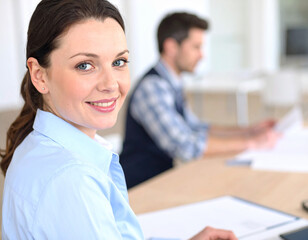 Obraz premium Happy young couple working on a laptop at their new home office desk