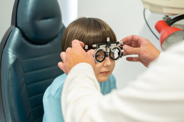 An ophthalmologist examines a little boy using modern equipment