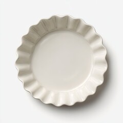 Off-white ceramic pie dish with a scalloped, fluted edge, shown from an overhead perspective against a bright white background