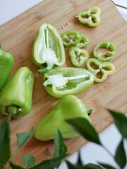 Green sweet pepper, whole and cut pieces, minimal atyle food composition, top view.