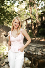 Beautiful girl near a landscaped stream.