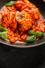 Stuffed cabbage tomato sauce with beans meat, cabbage, fresh delicious gourmet food background on the table rustic food top view copy space