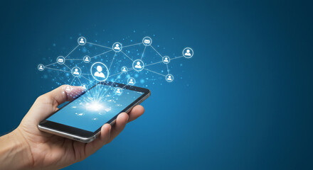 Hand holding a smartphone with a network of connected people icons emanating from the screen against a blue background, symbolizing connectivity.